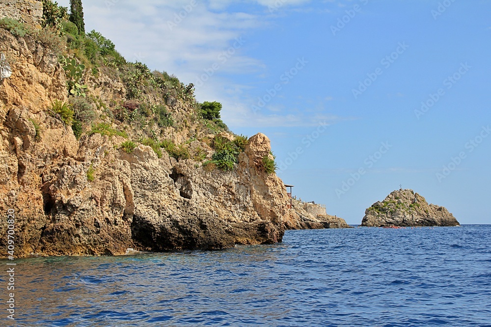 blue sea water, rocks, a cave carved in the rock, a cave in the rocks by the sea, a blue cave in Sicily, Italy,