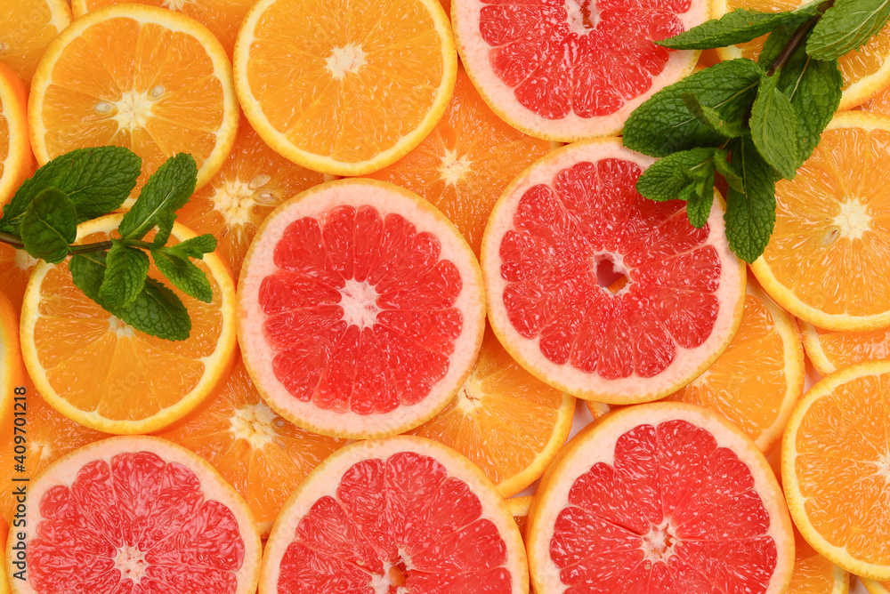 Slices of oranges and a grapefruits and mint as a background. Slices of oranges and a grapefruits and mint as a background.