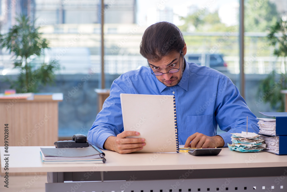 Fototapeta premium Young male bookkeeper in budget planning concept