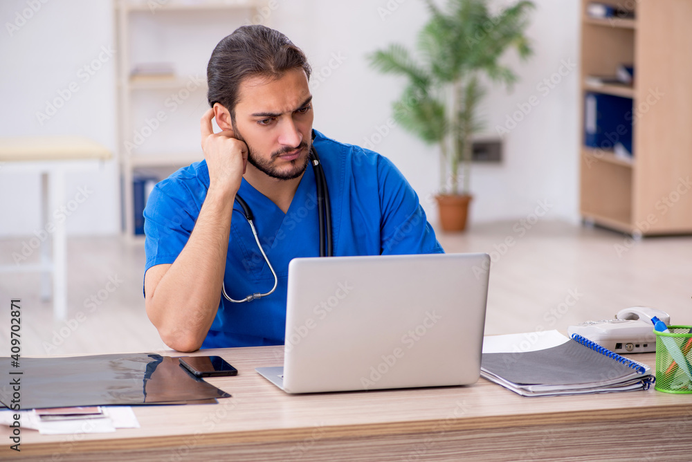 Young male doctor in telemedicine concept Young male doctor in telemedicine concept