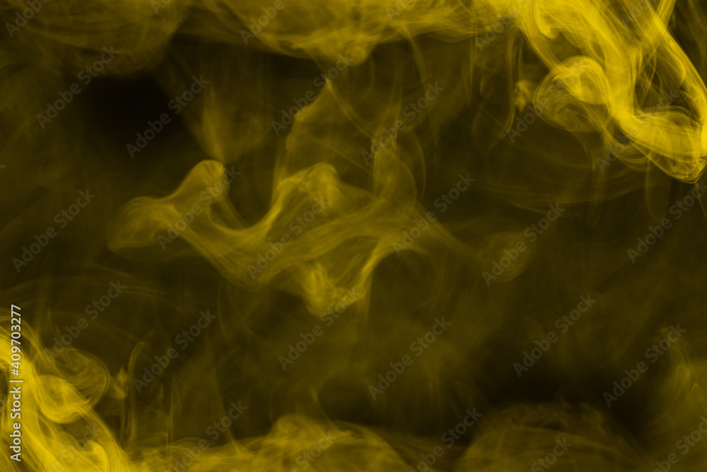 Fototapeta premium Yellow steam on a black background.