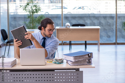 Young male accountant working in the office