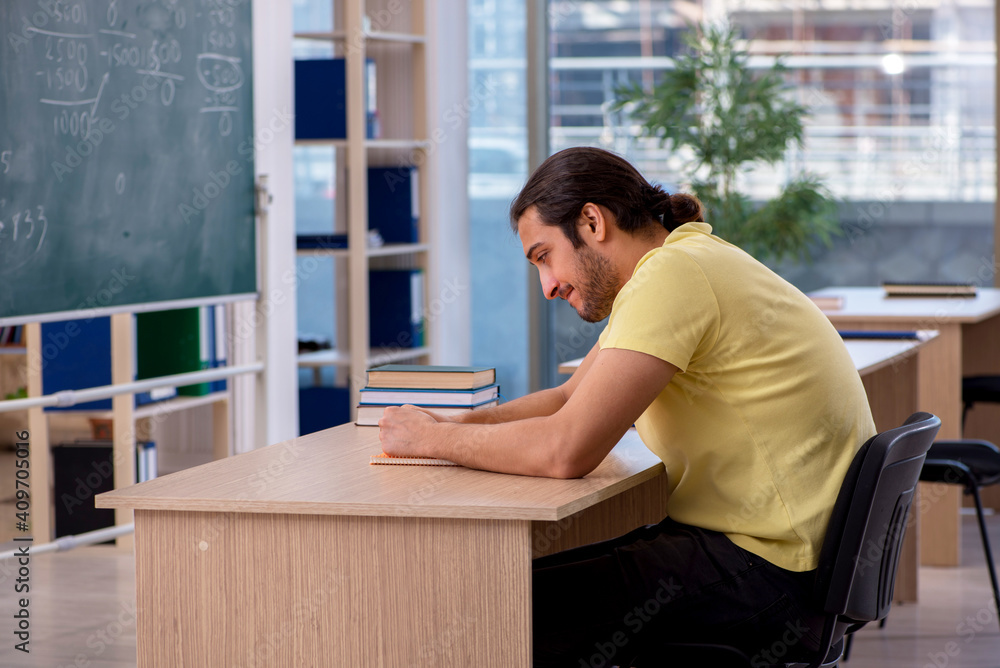 Young male student sitting in the classroom Young male student sitting in the classroom