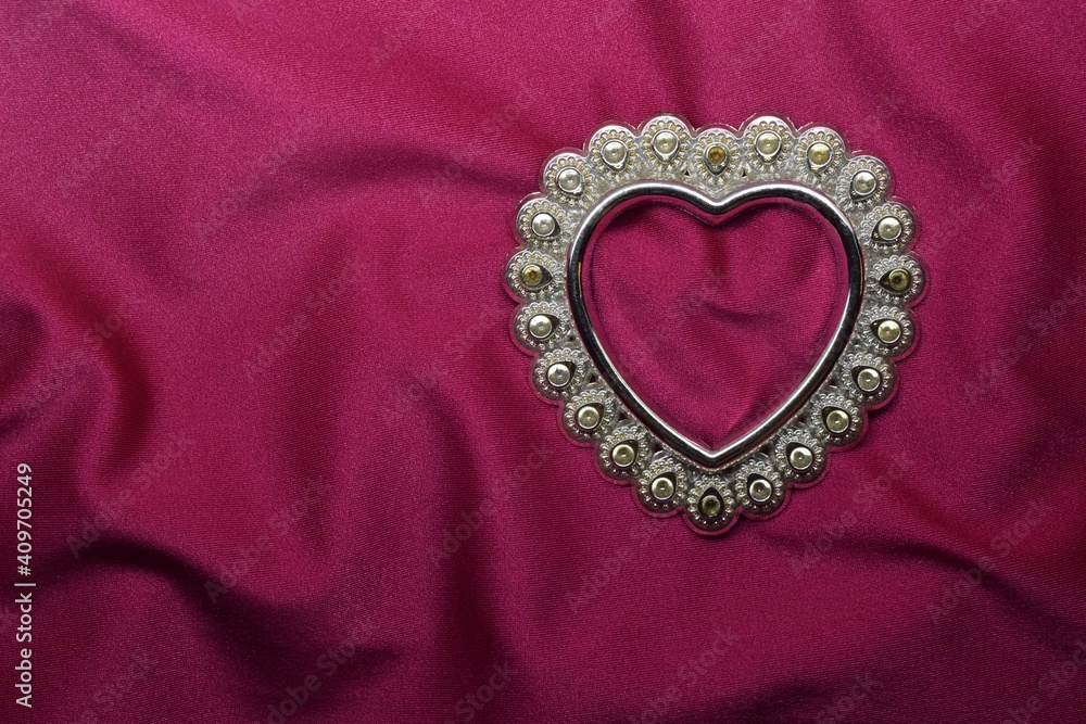 heart pin on a background of pink textured linen fabric. Valentine concept. heart pin on a background of pink textured linen fabric. Valentine concept.