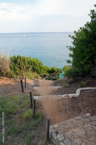 Path with some steps and old picket fence to go down on a beach. Marina di Camerota, Salerno, Italy.