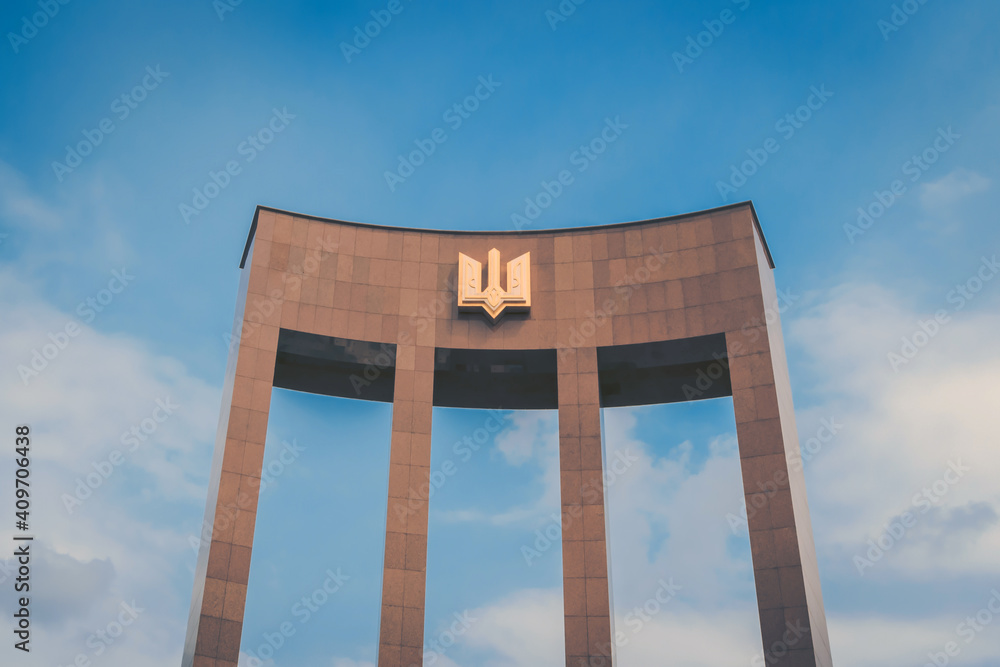 Arch with the emblem of Ukraine on a clear blue sky. Arch with the emblem of Ukraine on a clear blue sky.