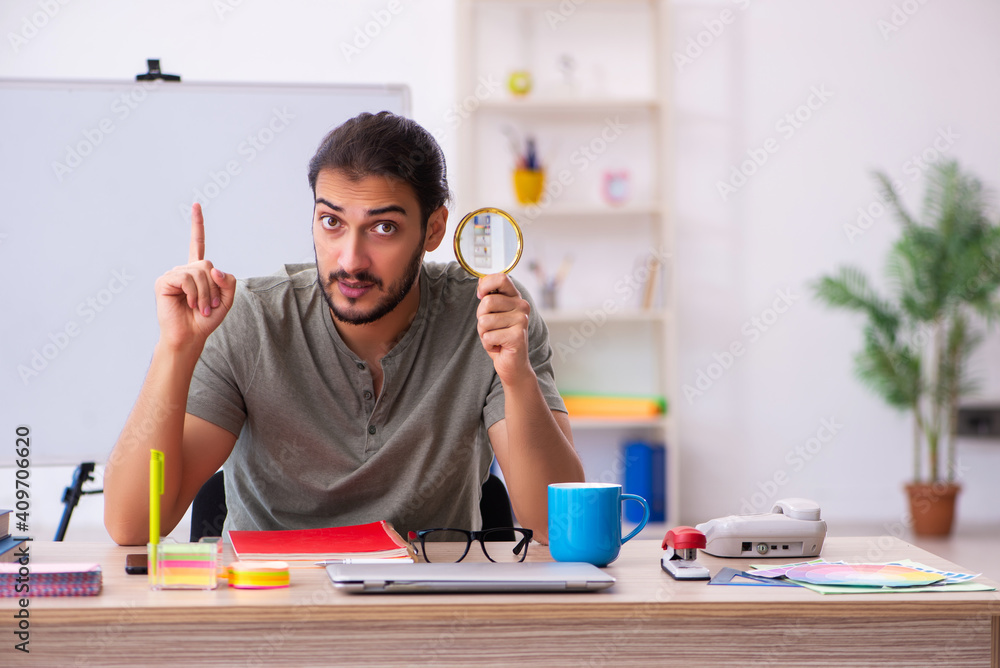 Young male designer working in the office Young male designer working in the office