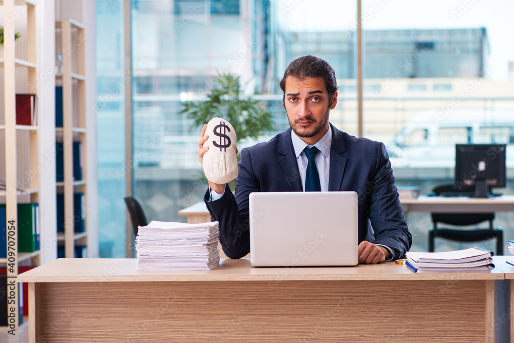 Young male employee in remuneration concept Young male employee in remuneration concept