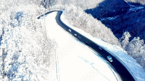 Aerial drone view of highway   and Lift cabin in the forest in winter