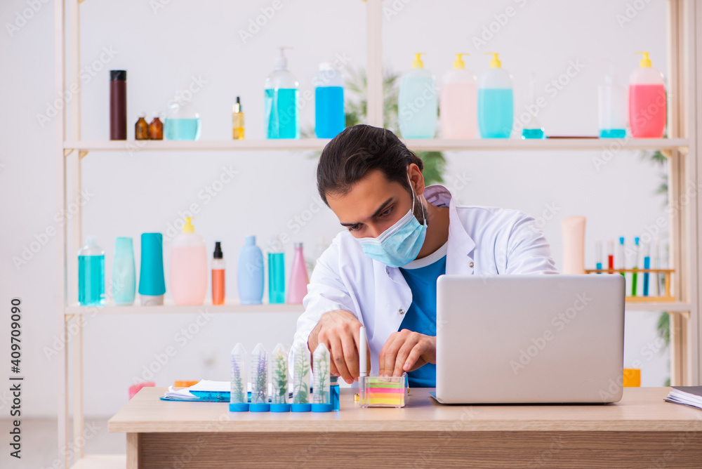 Young male chemist testing soap in the lab Young male chemist testing soap in the lab