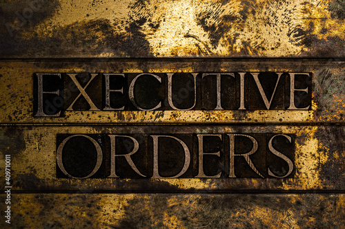 Executive Orders on grunge textured copper and gold steampunk style background photo