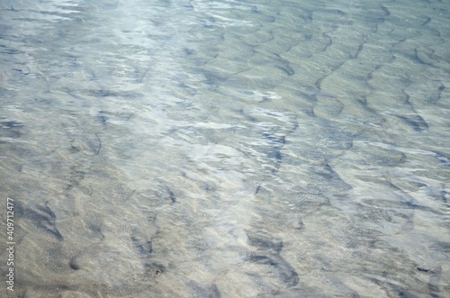 water surface with sandy bottom