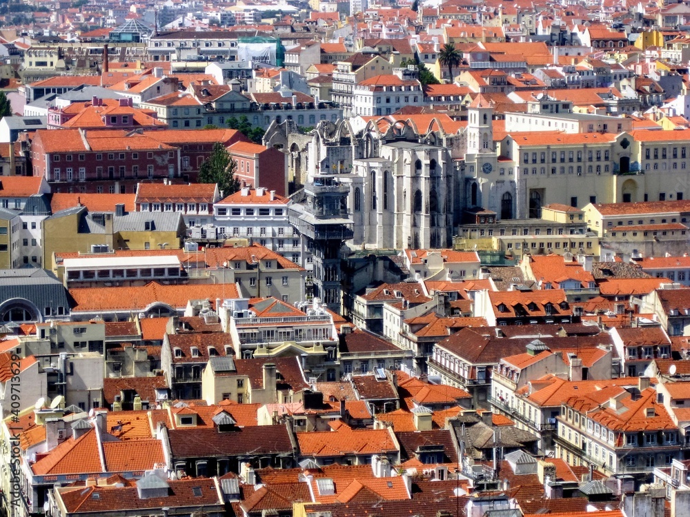 Naklejka premium Aerial view of Lisbon Baixa district with Santa Justa Lift (Carmo Lift) and ruins of historical Gothic church Convent of Our Lady of Mount Carmel (Igreja do Carmo), destroyed by earthquake in 1755.