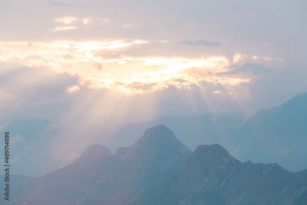 Obraz premium Foggy mountain sunrise. Clouds in the morning over the mountains. Colorful travel background.