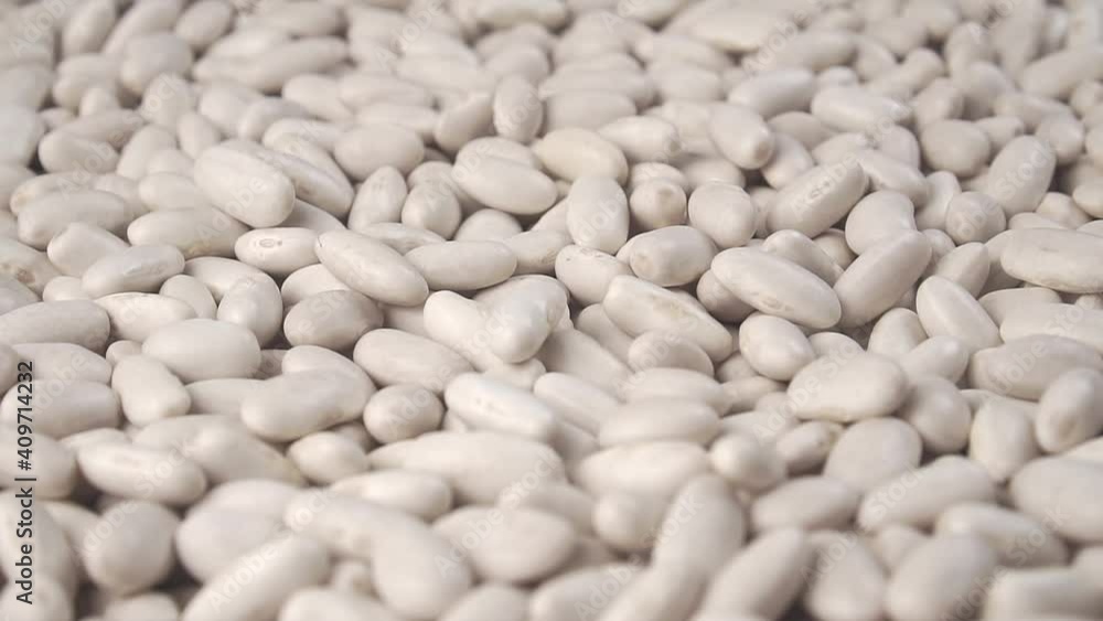 White beans fall into a heap in slow motion with rotation. Legumes close up White beans fall into a heap in slow motion with rotation. Legumes close up