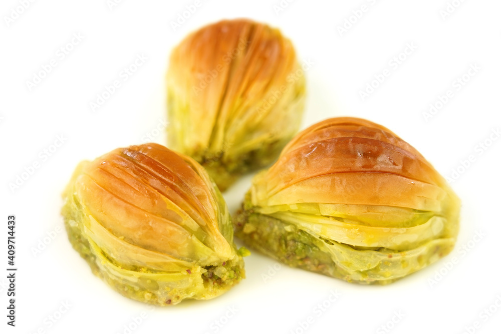 Turkish Midye Baklava ( Mussel Shape Baklava ) with green pistachio nuts. Turkish Midye Baklava ( Mussel Shape Baklava ) with green pistachio nuts.