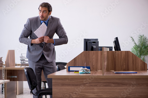 Tableau sur toile Young male employee in industrial espionage concept