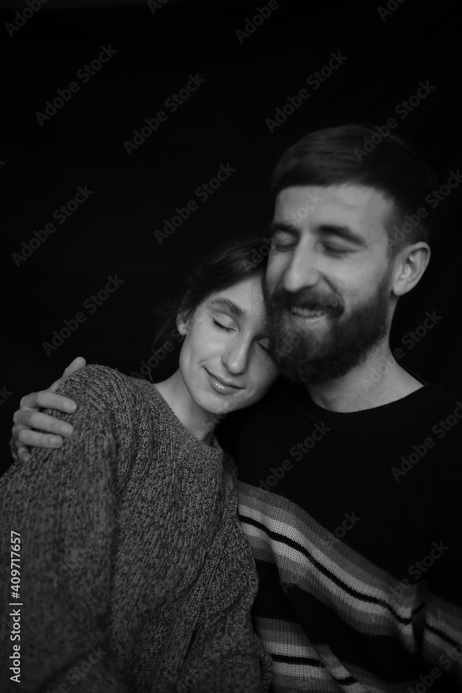 black and white portrait of a loving couple close-up on a black background. Couple in love. A family. Valentine's Day. black and white portrait of a loving couple close-up on a black background. Couple in love. A family. Valentine's Day.