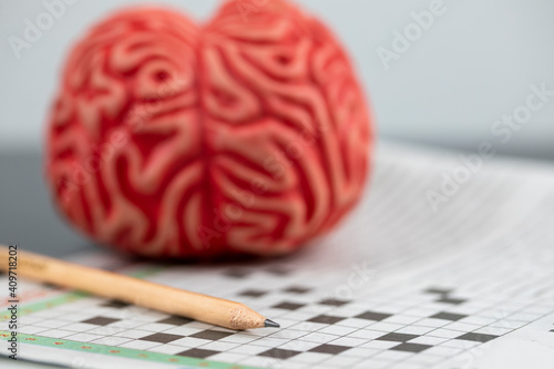 Alzheimer and brain training concept, Brain and crossword Puzzle with pencil photo