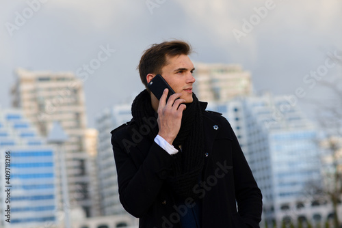 Young man on the street and in cafe with mobile phone, computer.