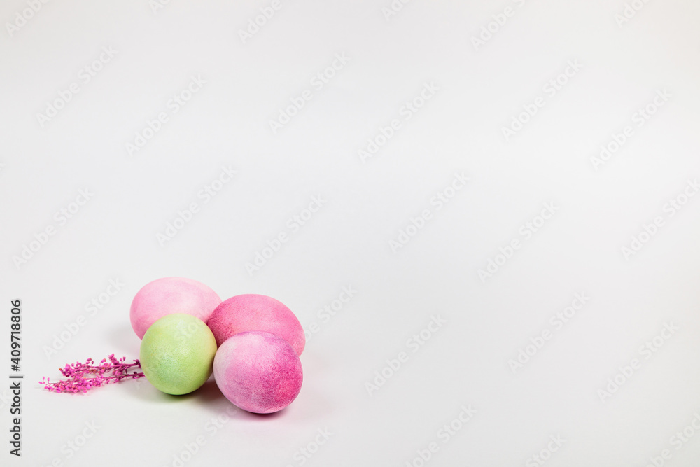 Multi-colored eggs with twigs, on a white background with a place for text. Multi-colored eggs with twigs, on a white background with a place for text.