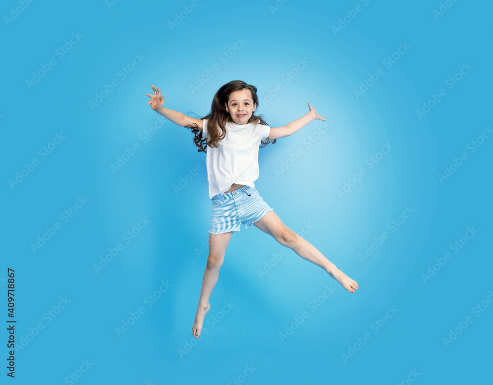Portrait of a cute, jumping little girl