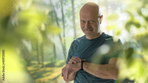 Middle aged athlete checking his smart watch © StockPhotoPro