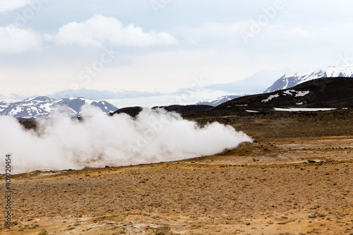  Colourful volcanic landscape with steam flowing from a vent in the Hverir geothermal park near lake Myvatn, Iceland