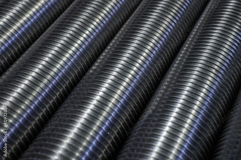 Large-diameter industrial steel bolts without heads, used in the assembly of structures in mechanical engineering, in the warehouse of finished products Large-diameter industrial steel bolts without heads, used in the assembly of structures in mechanical engineering, in the warehouse of finished products