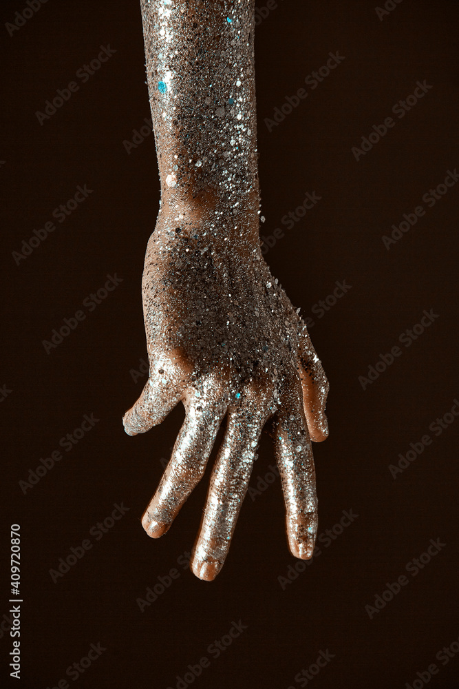 Obraz premium Glittering silver body art on female hand, close up of sparkling woman's arm, skincare concept