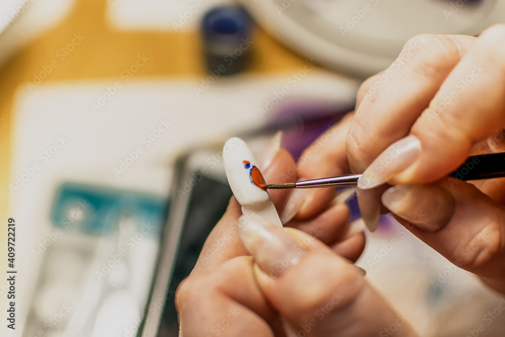 Learn the art of manicure. She draws on her fingertips and is trained in art design Learn the art of manicure. She draws on her fingertips and is trained in art design