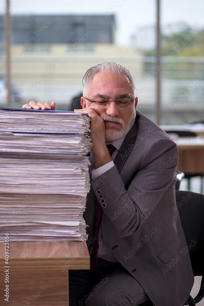 Old businessman employee and too much work in the office Old businessman employee and too much work in the office