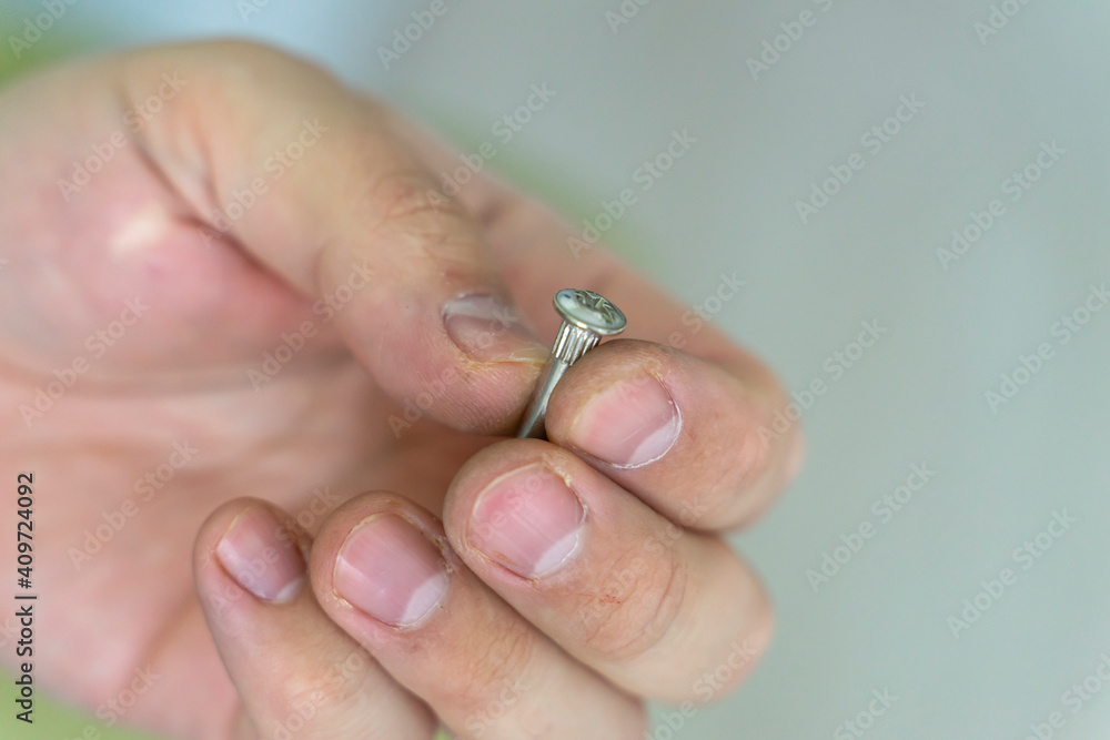 foreman's working hand holds a screw close-up foreman's working hand holds a screw close-up