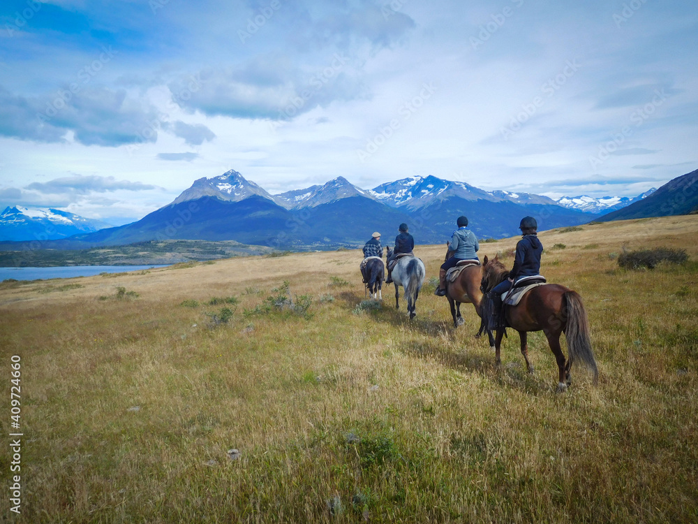 Four pepope enyojing to horse riding in Patagonia, Torres del Paine national park, near the lago Sophia, Puerto Natales. Incredible landscape. - obrazy, fototapety, plakaty 