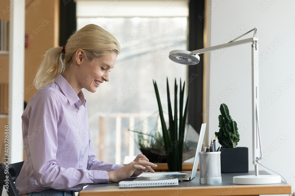 Happy businesswoman working at computer from home office. Employee typing on laptop and enjoying job. Company owner chatting online, giving consultation to client. Female small business leader concept Happy businesswoman working at computer from home office. Employee typing on laptop and enjoying job. Company owner chatting online, giving consultation to client. Female small business leader concept