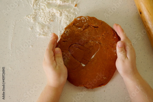children's hands make cookies from dough