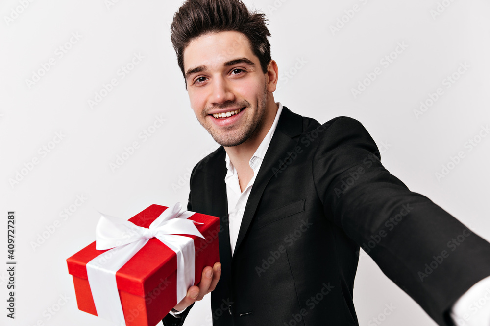 Blissful man with valentine's present making selfie. Studio shot of birthday boy isolated on white. Blissful man with valentine's present making selfie. Studio shot of birthday boy isolated on white.