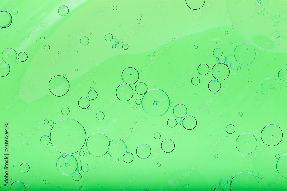 Oil mixed with water, abstract colorful background. Green background and texture.