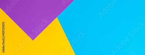 Color papers geometry flat composition background with yellow purple and blue tones