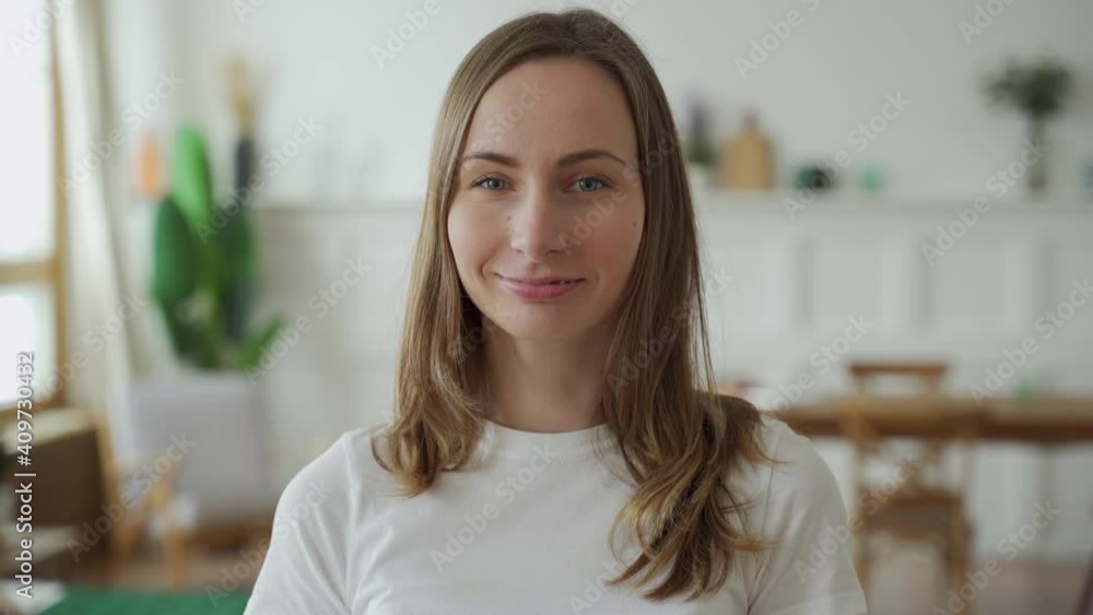 Portrait of a positive emotional woman who smiles while looking at the camera Portrait of a positive emotional woman who smiles while looking at the camera
