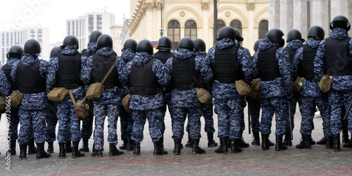 Police officers stand in a cordon on unauthorized political rally in support of the arrested opposition leader Alexei Navalny on january 31, 2021 on Komsomolskaya Square in Moscow . Rear view. photo
