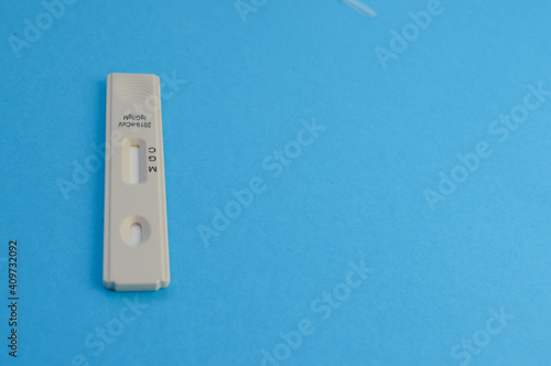 white test strip for the diagnosis of coronavirus infection. test on a blue background. individual kit for the diagnosis of the disease. determination of IgG and IgM antibodies