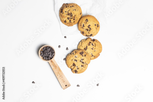 top view cookies with spoon full of chocolate chips on white background 