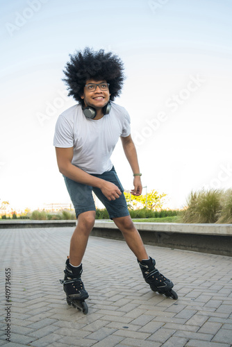 Latin man rollerskating on the street.