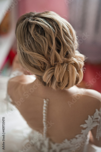 The brides beautiful wedding hairstyle is decorated in a bun 2562.