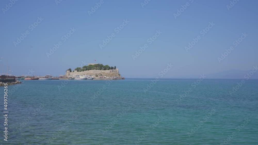 Old castle with turkish flag on sea cape in Kusadasi city of Turkey. Travel and tourism concept. Old castle with turkish flag on sea cape in Kusadasi city of Turkey. Travel and tourism concept.