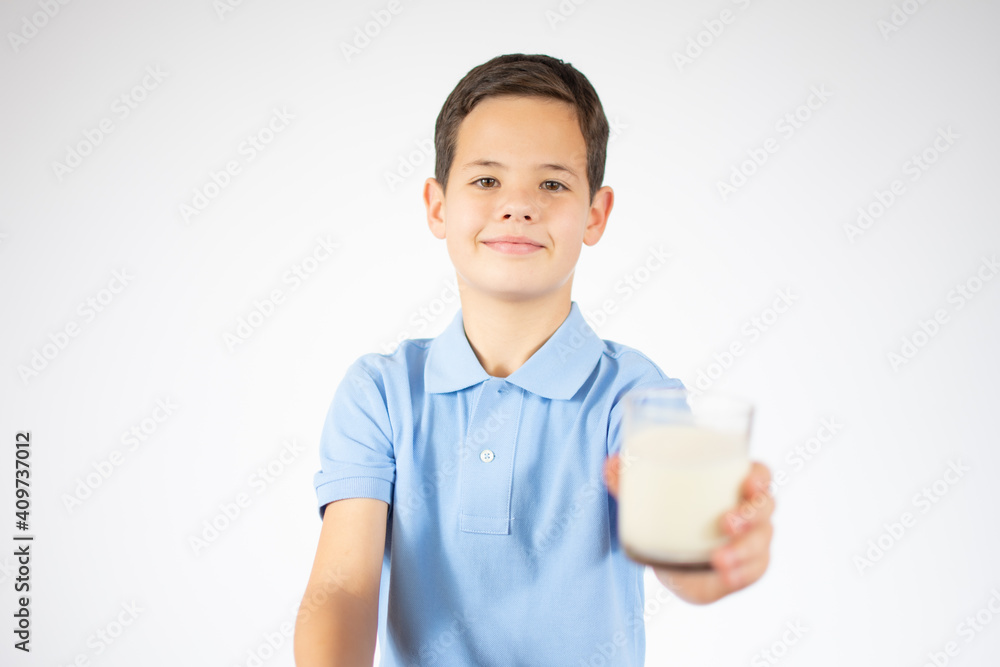 ute boy in blue shirt holding glass of milk on white background ute boy in blue shirt holding glass of milk on white background