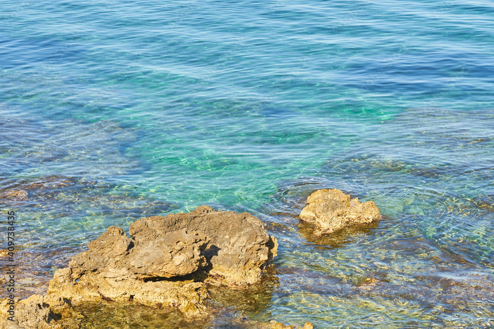 The rocky coast of the mediterranean sea with turquoise water as a natural background.