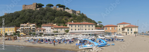 Panorama of Castiglione della Pescaia from the pier at the mouth of the Bruna river. In the foreground the beach and in the background the upper part of the village with the walls and the castle.