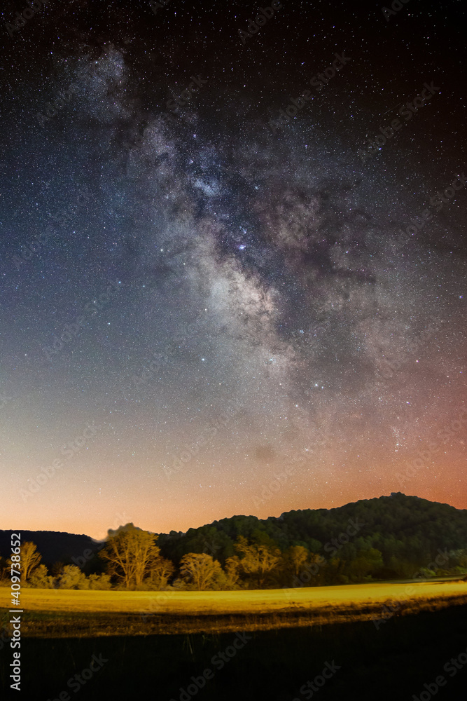 Beautiful scenery of the Milky Way galaxy in the night sky over a landscape - obrazy, fototapety, plakaty 